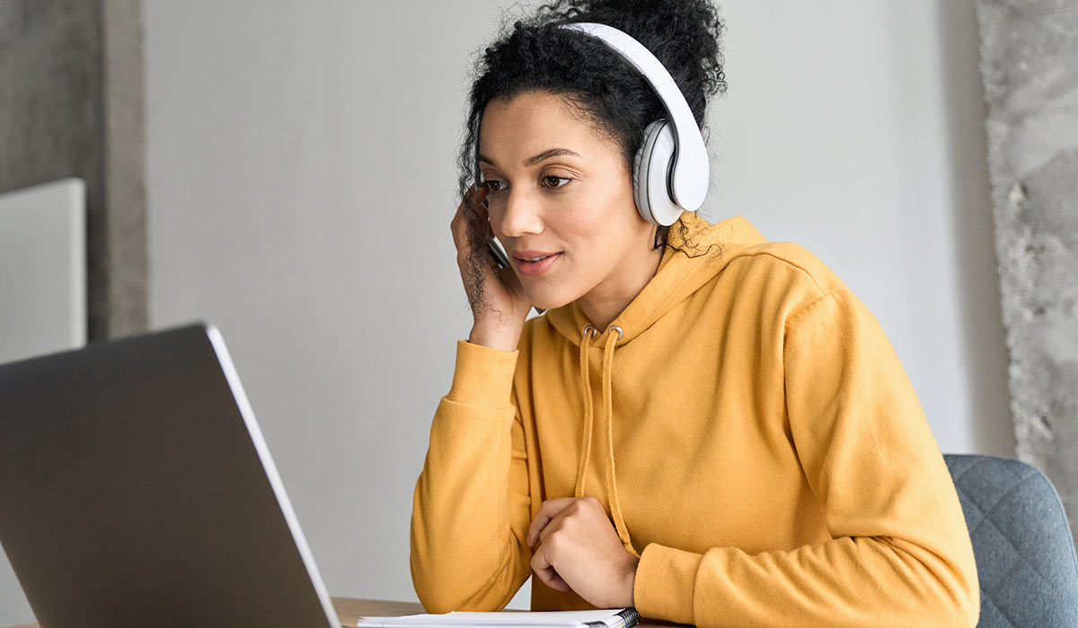 A woman watching an online training.